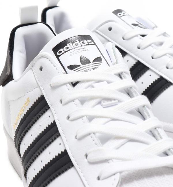 Adidas superstar black 2024 and gold stripes